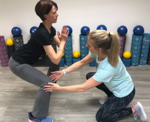 Christina Verhorevoort, PT, DPT correcting form - Newton North High School Women in STEM Day presentation